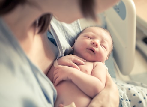 woman holding newborn child